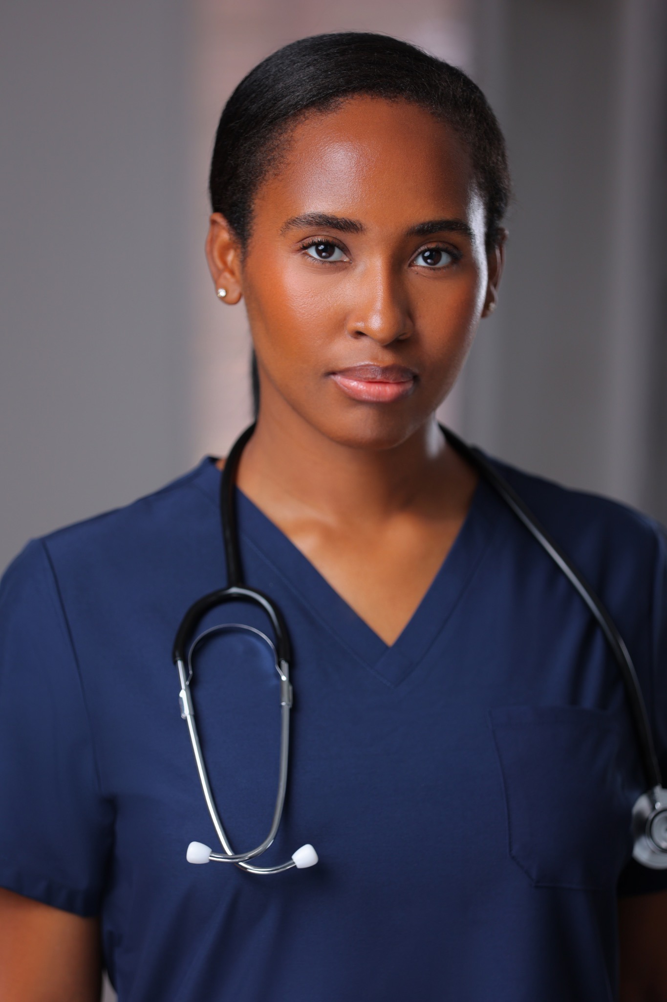 Elle Jean-Barre in medical scrubs on set